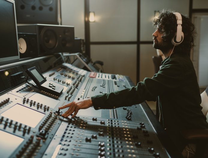 side view of concentrated sound producer working at studio side view of concentrated sound producer working at studio