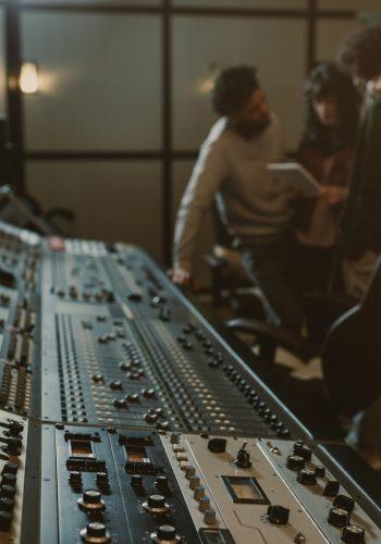 blurred group of musicians spending time at recording studio wit blurred group of musicians spending time at recording studio with graphic equalizer